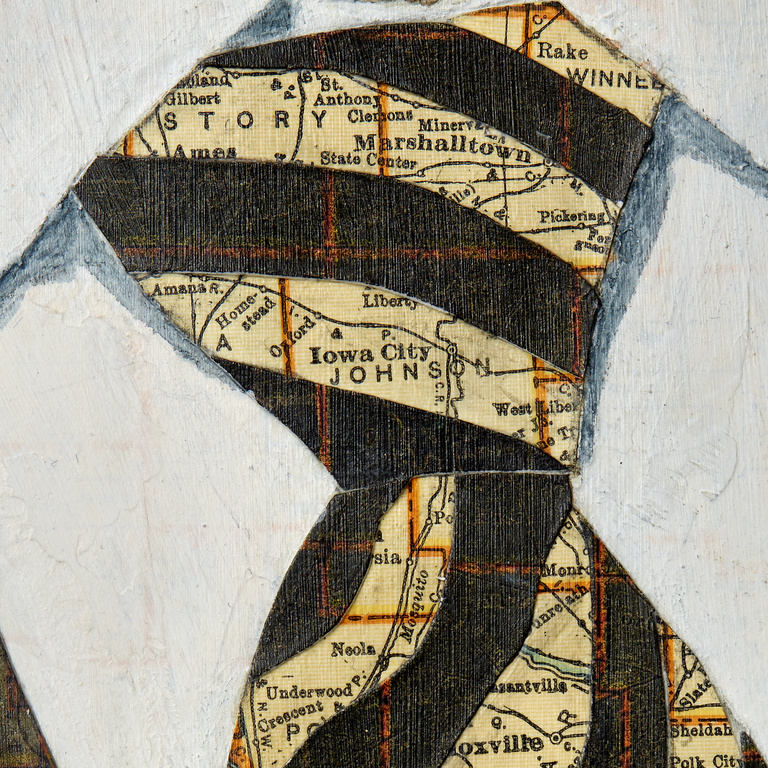 Close-up of Collins' black and gold tie made from collaged Iowa maps, featuring Marshalltown and Iowa City. 