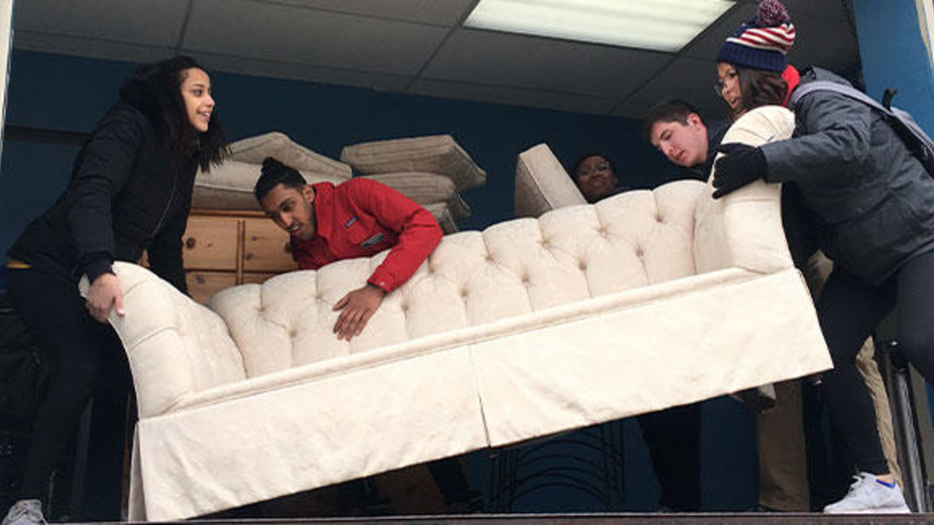 Students moving a sofa
