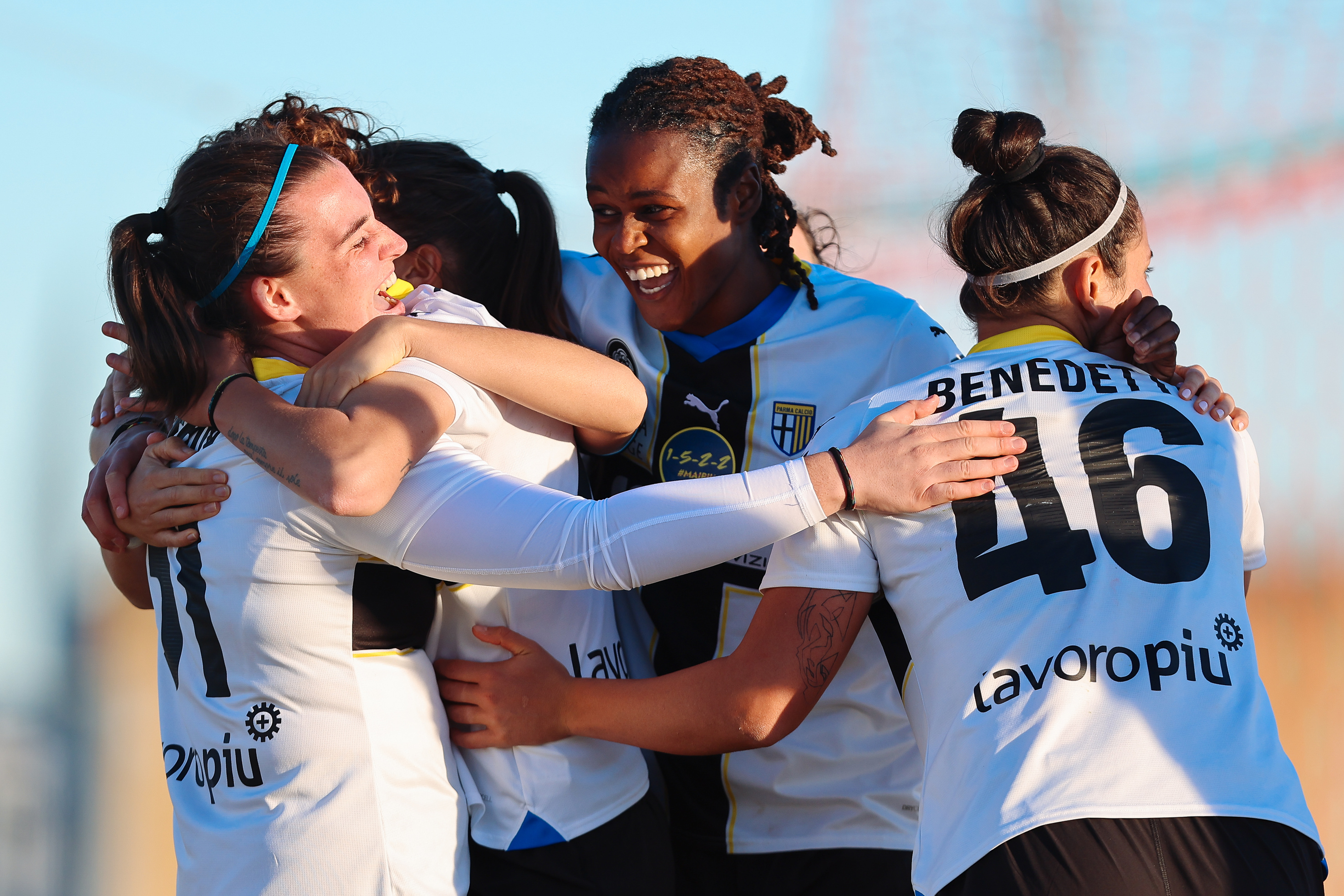 The Parma women's team celebrating a goal. 