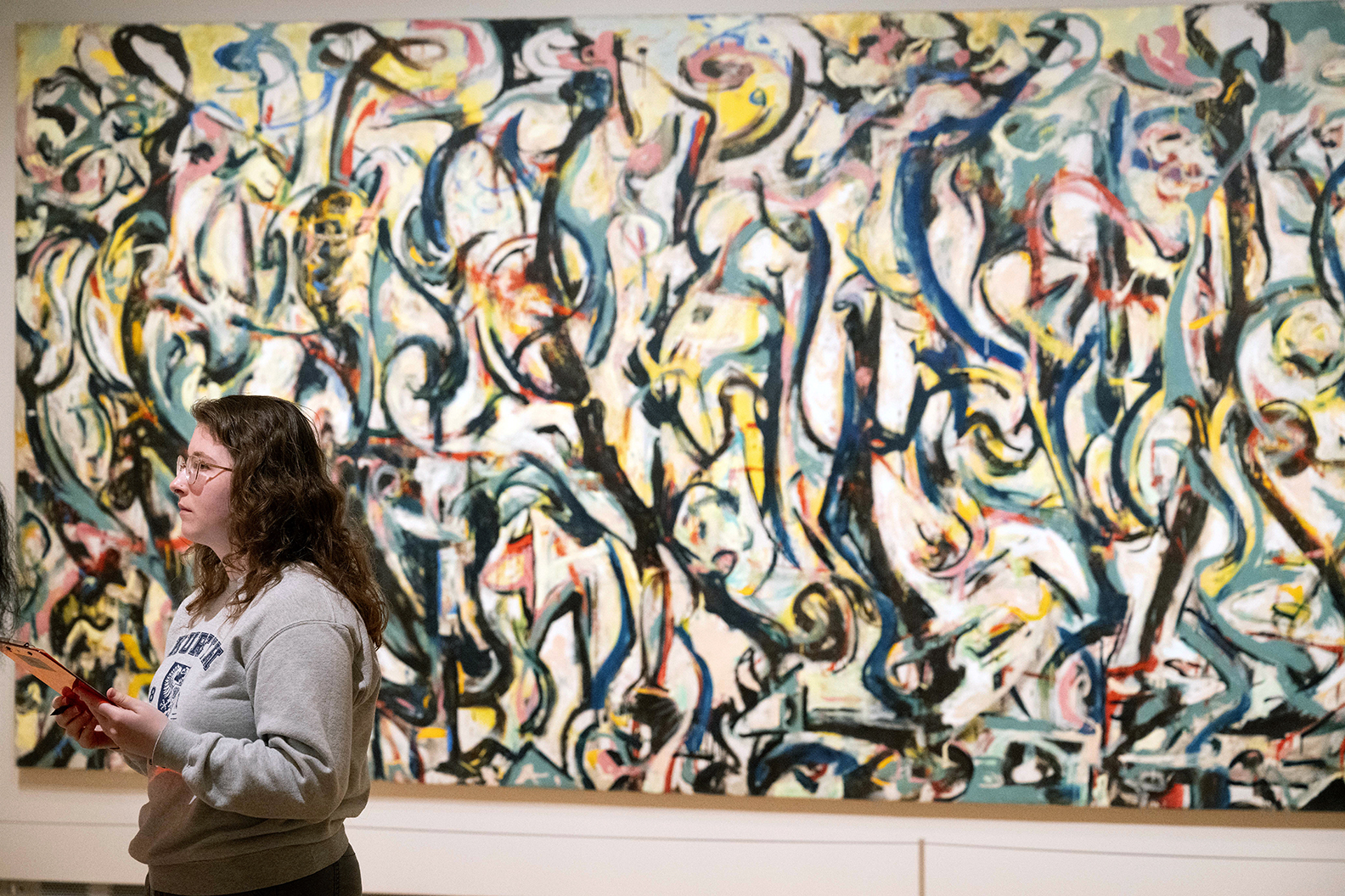 A student in front of Jackson Pollock's "Mural."