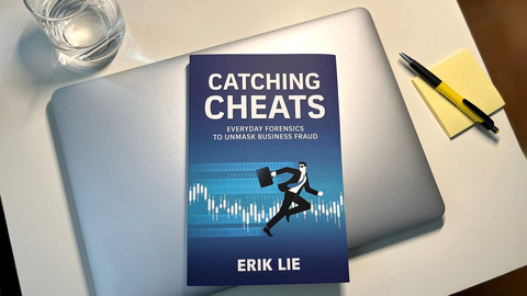 The book "Catching Cheats" sitting on a table