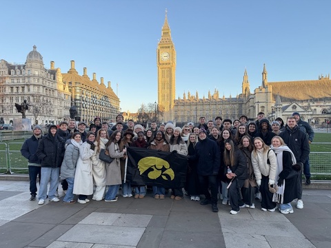 The Insurtech study abroad group posing in London with tigerhawk flag
