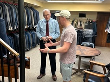 Bob Noser helps customer Brady Glissman select a blazer.