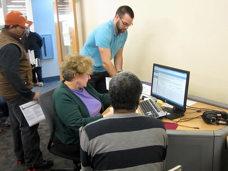 Joyce helping VITA participants file their taxes.