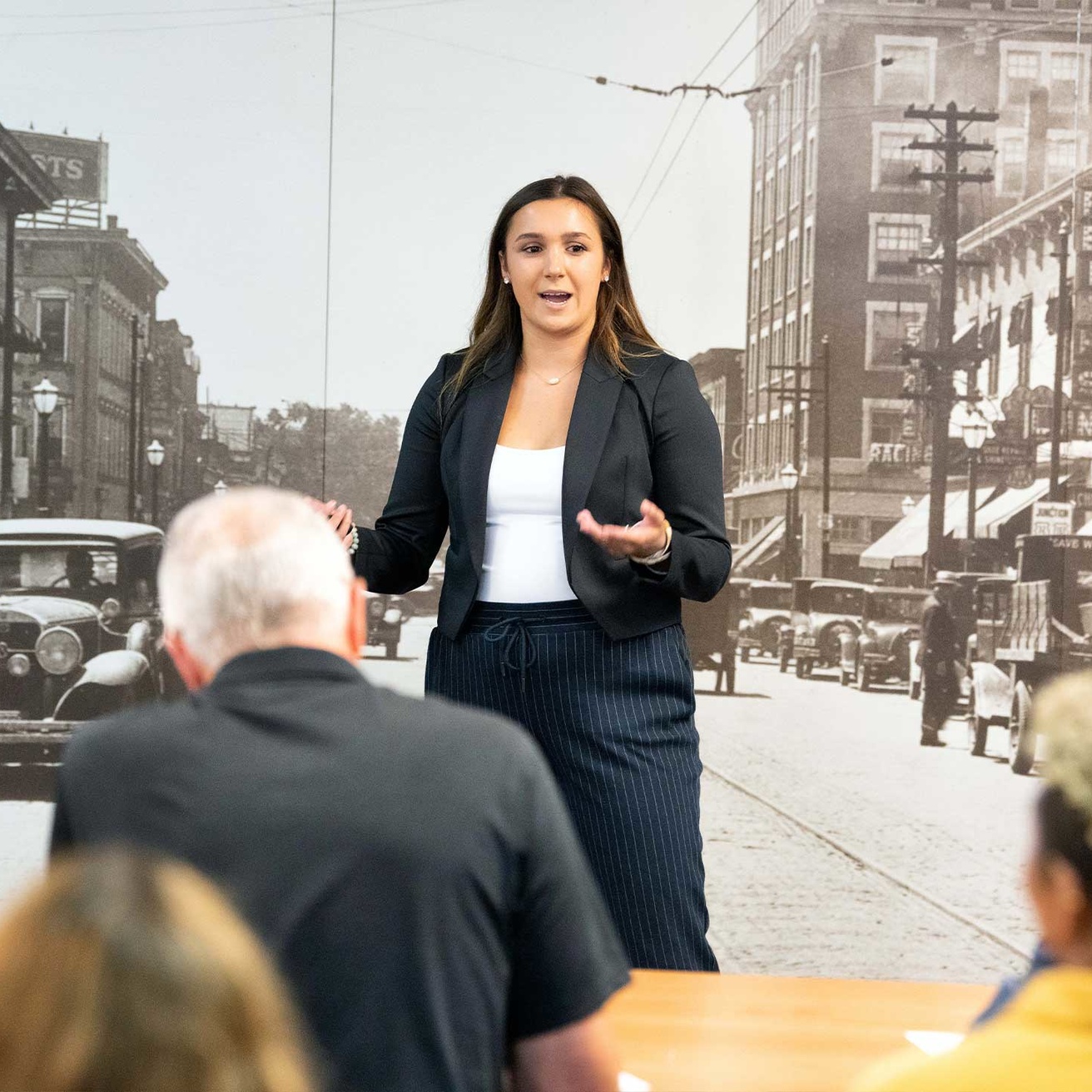 Woman student standing up and presenting to a group of people