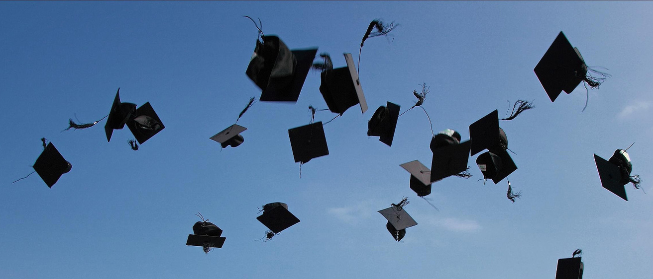 Graduation caps thrown into the  air