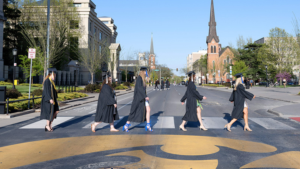 UI graduates walking across Jefferson Street