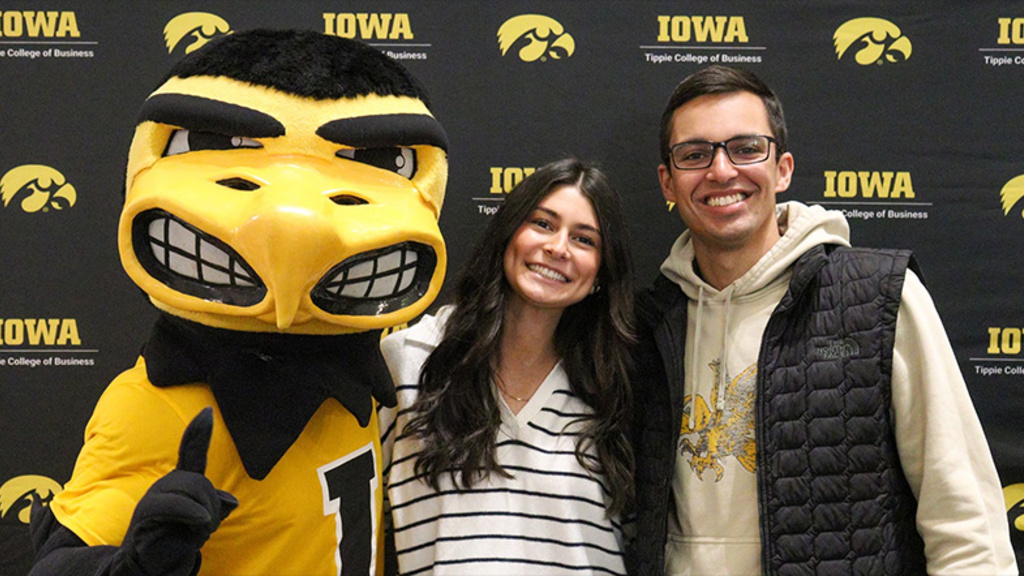 Two Tippie students with Herky the Hawk